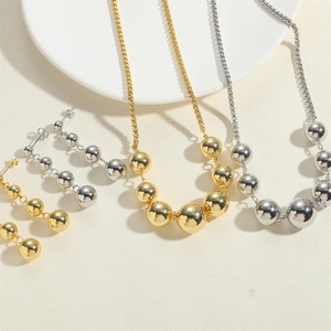 Detailed view of 14K gold and silver bead jewelry sets featuring necklaces and earrings