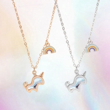 Detailed view of unicorn and rainbow necklaces in rose gold and silver finishes