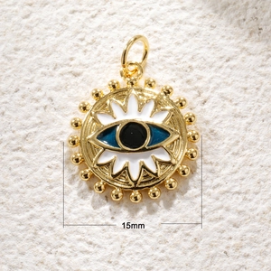 Macro view of 15mm gold-plated evil eye pendant with blue enamel on stone surface