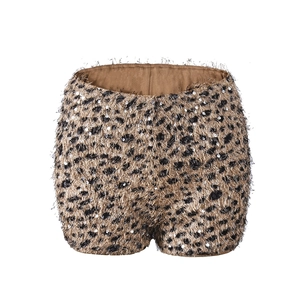 Detail of leopard print sequins shorts with shimmering texture and fringe edges