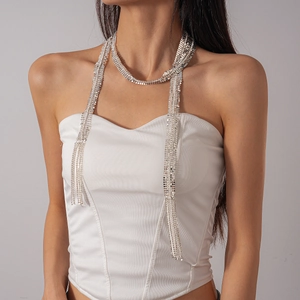 Silver fringe necklace with glittering rhinestones worn by a model in a close-up detail shot