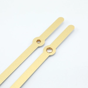 Golden brushed metal clock hands with center mounting holes for DIY wall clock assembly