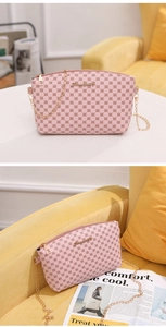 Detailed view of pink printed crossbody bag with textured PU finish and gold chain strap