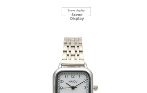 Detail view of square silver steel watch with white dial and black Arabic numerals