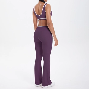 Detail of purple yoga set showing white contrast trim on sports bra and flared pants