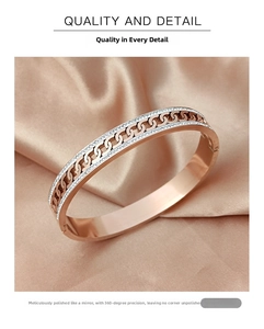 Detail of rose gold bangle featuring hollow chain design and pavé rhinestones
