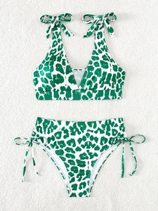 Flat lay of ribbed bikini set with green leopard print and adjustable shoulder ties