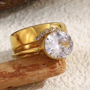 Detailed macro view of 18K gold plated ring featuring two large oval zircon stones on wood