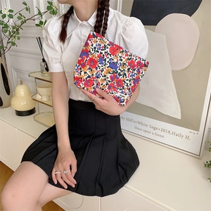 Floral cotton makeup bag shown in a lifestyle home setting with Suzakka brand detail