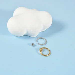 Close-up of gold and silver steel BCR captive bead rings with opal and small diamond accents
