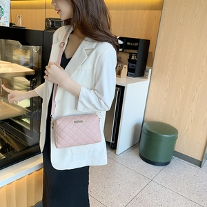 Pink quilted crossbody bag for women with gold hardware shown on a model in a cafe