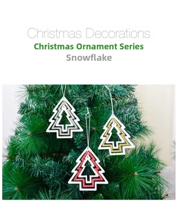 Detail of glittery hollow Christmas tree ornaments in festive red, gold and silver finishes