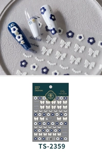 Close-up of 5D embossed nail stickers featuring blue plumeria and bow designs