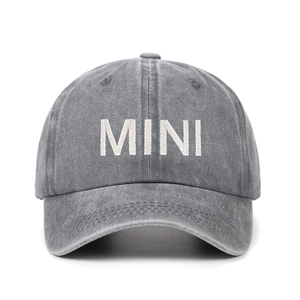 Detail of grey washed cotton baseball cap featuring white MINI embroidery and curved brim