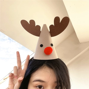 Detail of Christmas reindeer hat with felt antlers and red plush nose worn by a model