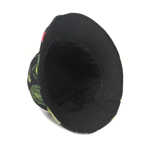 Close-up of reversible bucket hat featuring realistic green vegetable patterns and wide brim