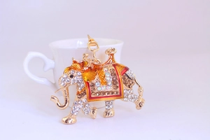 Detailed close-up of a golden elephant keychain with sparkling rhinestones and red enamel