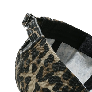 Detail of the leopard print baseball cap featuring an adjustable silver metal buckle