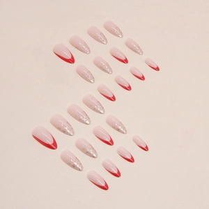 Almond press-on nails with red French tips and silver foil flakes on nude base