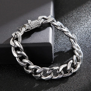 Macro detail of silver cuban link bracelet with sparkling diamond-set rectangular clasp