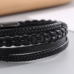 Macro shot of multi-layer black woven leather bracelet with matte magnetic steel clasp