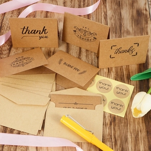 Detailed set of kraft paper thank you cards with envelopes and seals on wood background