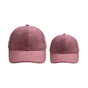 Detail of corduroy baseball caps in dusty rose showing adult and child size comparison