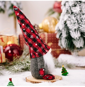 Close-up of Christmas gnome with red-black plaid snowflake hat on a wooden base
