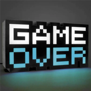 Macro detail of LED Game Over pixel light with glowing blue shadow on dark surface