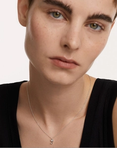 Close-up of S925 silver key pendant necklace with sparkling crystals worn by a model
