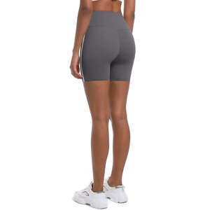 Macro detail of high-waist yoga shorts showing side stripes and lifted V-seam stitching