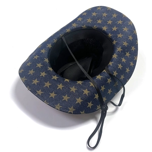 Top view of blue straw cowboy hat with gold stars, inner adjustable strap and chin cord