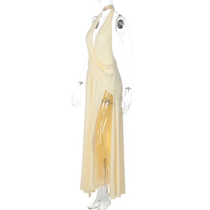 Detail view of yellow halter neck maxi dress with deep V-neck and high side slit