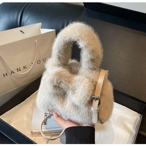 Detail showing plush rabbit shoulder bag texture with beige faux fur and leather strap