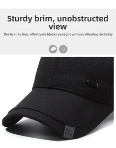 Detail of black baseball cap showing SPORT FASHION label and metal brand plate
