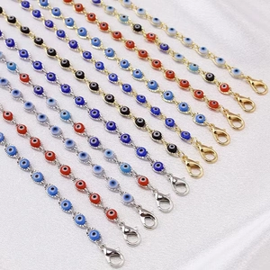 Detailed macro view of colorful evil eye charms on golden and silver link bracelets