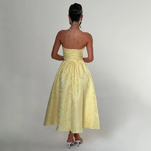 Detail of yellow backless jacquard tube dress with elegant lace-up cross straps on the back