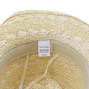 Inside view of a paper straw cowboy hat showing the 57cm size label and washing icons