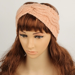 Macro detail of the peach pink knitted texture and twist knot on the winter headband