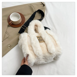 Detailed texture of cream fuzzy tote bag featuring Have a Nice Day woven label
