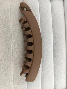 Detail of brown matte banana hair clip showing secure grip teeth and minimalist finish