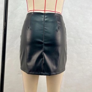 Detail view of the black PU leather skirt featuring a hidden back zipper and fitted cut