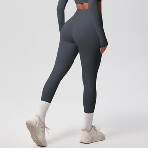 Rear view of tight dark gray yoga set featuring high waisted leggings and cropped top