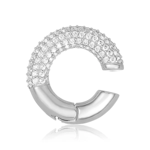 Detailed view of silver C-shaped ear cuff with pave-set zircons on white background