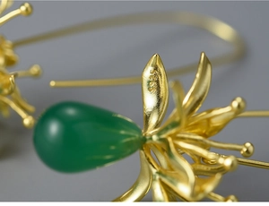 Macro shot of S925 hallmark on gold lily earrings with green chalcedony drop