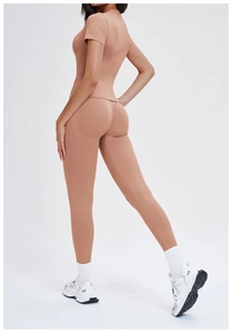 Close-up of seamless high-waist yoga pants in khaki, showing body-shaping fit and fabric texture