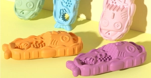 Detail showing colorful cartoon fishbone slippers for dogs in vibrant candy colors