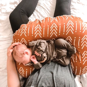 Elastic U-shaped nursing pillow cover in burnt orange with white geometric arrow patterns