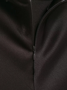 Détail d'une fermeture éclair invisible sur un tissu en satin noir soyeux