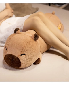 Close-up of soft plush capybara body pillow featuring detailed cute sleeping face and texture